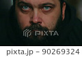 A man with a beard looks sadly at the camera and touches his beard, static camera, close-up of the face 90269324