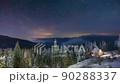 Snow covered mountain in winter, sky view and snowfall, sky changing from yellow hues at dawn to blue hues at noon 90288337