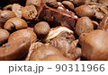 Extreme close-up of detailed coffee beans and bittersweet chocolate chunks with whole hazelnuts 90311966