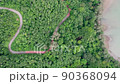 Top view of countryside road passing through the green forrest and mountain 90368094