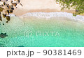 Beautiful 4K tropical beach aerial - a bird's eye view of ocean waves crashing against an empty beach from above 90381469