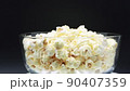 Pour Popcorn into a rotating glass on a Black background. 90407359