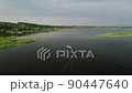 Aerial view of a fishing boat moving along river. Fisherman in motorboat during fishing in river. Fishing for river fish from a motor boat using a fishing rod or spinning rod. Rest in the wild. 90447640