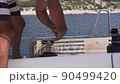 Man work with winch on the yacht 90499420