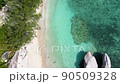 Beautiful 4K tropical beach aerial - a bird's eye view of ocean waves crashing against an empty beach from above 90509328