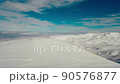 Aerial view snow mountain peak clouds in background 4k winter drone footage Ski resort 90576877