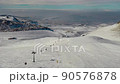 Aerial view snow mountain peak clouds in background 4k winter drone footage Ski resort 90576878