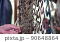 Womens hands weaving camouflage net for army, volunteers make camouflage protection for military needs, selective focus 90648864