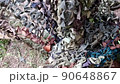 Womens hands weaving camouflage net for army, volunteers make camouflage protection for military needs, selective focus 90648867