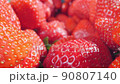 extreme close-up of a bunch of ripe strawberries, detailed 90807140