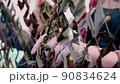 Womens hands weaving camouflage net for army, volunteers make camouflage protection for military needs, selective focus 90834624