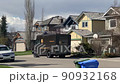 Calgary, Alberta, Canada. May 22, 2022. A UPS truck park in front a house and a delivery person taking a package. 90932168