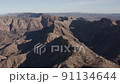 Aerial drone view of a group of rugged mountains, as part of a larger range, in an arid climate 91134644