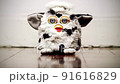 old  Furby  toy on a wooden floor loop 91616829