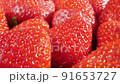 extreme close-up of a bunch of ripe strawberries, detailed 91653727