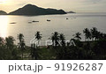 Aerial view moving fishing boat at the ocean. Top view sailing fishing boat. Ocean sea water wave reflections. Fishing boat trawler catch fish and sailing on sea at sunrise. Khanh Hoa, Vietnam 91926287