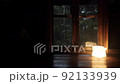 Mountain hut in the forest It rains outside the window Focus is from the outside to the inside 92133939