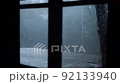 Mountain hut in the forest It rains outside the window The focus is outside 92133940