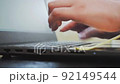 Close-up female hands typing on a laptop, working home, freelance, typing fingers on a keaboard 92149544