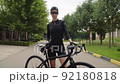 Beautiful summertime mood shot of young woman or girl riding bicycle 92180818