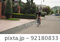 Beautiful summertime mood shot of young woman or girl riding bicycle 92180833