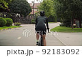 Young stylish brunette woman rides bike 92183092
