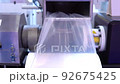 Part of the mechanism for making plastic bags is a moving roller with a flat plastic film. Automated technological equipment. 92675425