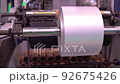 Part of the mechanism for making plastic bags is a moving roller with a flat plastic film. Automated technological equipment. 92675426