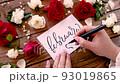 Writing FEBRUARY and drawing heart on a card near flowers close up 93019865