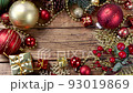 Copy space between Christmas decorations on a brown wooden table top view 93019869