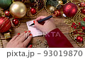 Woman's hand writing BIG SALE on a card on the wooden table with Christmas decorations around close up 93019870