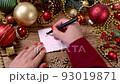 Woman's hand writing SALE on a card on the wooden table with Christmas decorations around close up 93019871