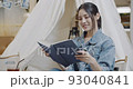 A beautiful Asian woman is happy to read a book. Slow Motion 4K DCI  93040841