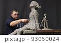 Man sculptor creates sculpt bust clay human woman sculpture. Statue craft creation workshop. 93050024