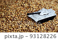 Tank stands on dried grain that falls on top 93128226