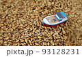 small toy boat falls asleep with grain falling from above 93128231