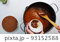 Housewife cooks sauce in a saucepan 93152588