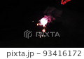 Hand-held fireworks spark of purple light 93416172