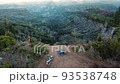 Aerial View Of Motorcycle And Camping Equipment On The Mountain With Scenic View At Sunrise. - ascend 93538748