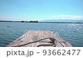 Small wooden boat head traveling in an open water. 93662477
