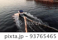Aerial drone top view with copy space of luxury speed boat cruising in high speed in blue sea. Reflection of the sailing yatch and golden sunset in water. Leisure time at nautical vessel in the ocean 93765465