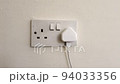 Plug in electrical appliance and switch on, UK British socket 94033356
