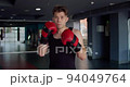 Portrait of a male boxer in a boxing gym. 94049764