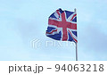British flag waving in wind on blue sky background, Union Flag or Union Jack 94063218