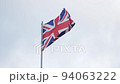 British flag waving in wind on gray sky background, Union Flag or Union Jack 94063222