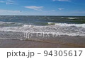 View of beautiful footage while big sea waves breaking on the coastline. Beach meeting deep Baltic sea water and foamy waves. 94305617