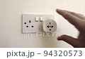 Plug in electrical appliance with adapter and switch on, UK British socket, european adapter 94320573