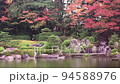 [Kyushu/Fukuoka] A panned video of the three-tiered waterfall in the Japanese garden of Ohori Park, Fukuoka Prefecture, wet in the autumn rain. 94588976