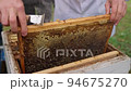 Bees fly and collect honey. The bees are getting ready for winter. Many bees that climb one on one in the evidence. Honey comb. 94675270