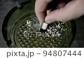 Cigarette is being put out in the ashtray 94807444